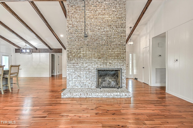 28 Kingsbridge St, Bristol, TN 37620 - unfurnished living room with high vaulted ceiling, wood finished floors, beamed ceiling, and a fireplace