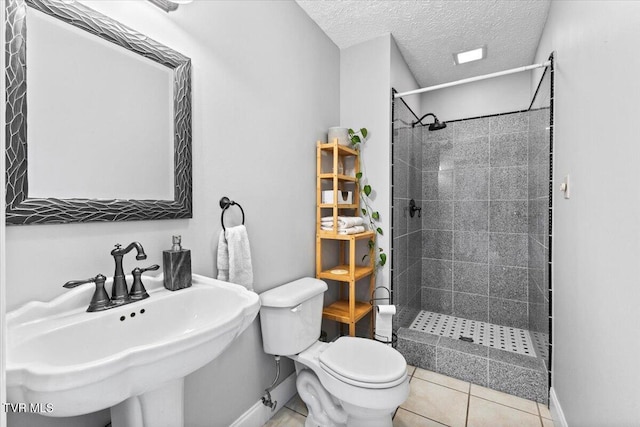 124 Highland Hills Dr, Gray, TN 37615 - full bathroom featuring baseboards, a sink, toilet, tiled shower, and a textured ceiling