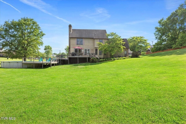 124 Highland Hills Dr, Gray, TN 37615 - back of property with a swimming pool, a chimney, a lawn, and a wooden deck