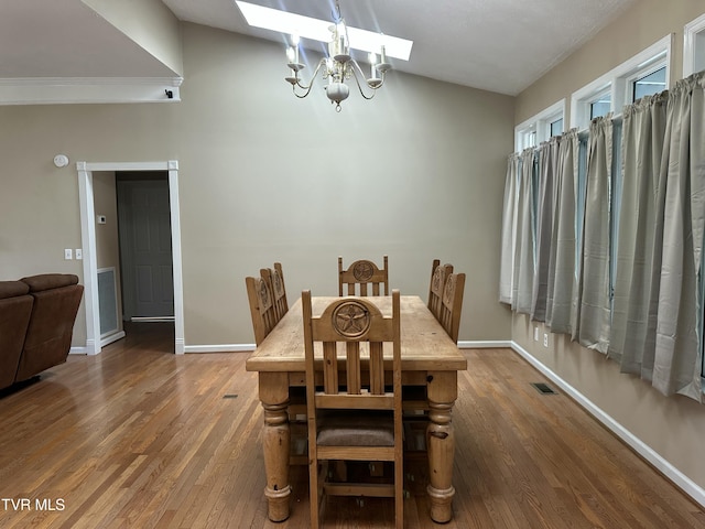 390 Springdale Dr, Bristol, TN 37620 - dining room with a skylight, wood finished floors, a chandelier, and baseboards