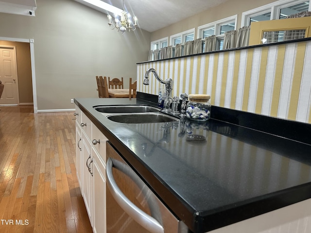 390 Springdale Dr, Bristol, TN 37620 - kitchen featuring a sink, dark countertops, light wood-style floors, baseboards, and white cabinetry