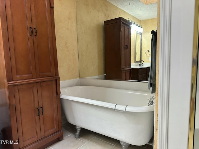 390 Springdale Dr, Bristol, TN 37620 - full bathroom with tile patterned floors, a freestanding bath, a textured ceiling, a textured wall, and vanity