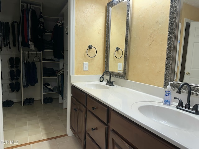 390 Springdale Dr, Bristol, TN 37620 - full bathroom with tile patterned flooring, a textured wall, a walk in closet, and double vanity