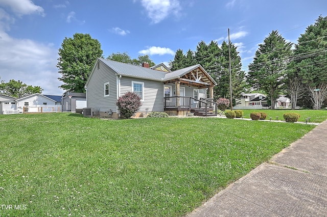 1401 Burgie St, Elizabethton, TN 37643 - ranch-style house featuring a porch, central AC, metal roof, and a front lawn
