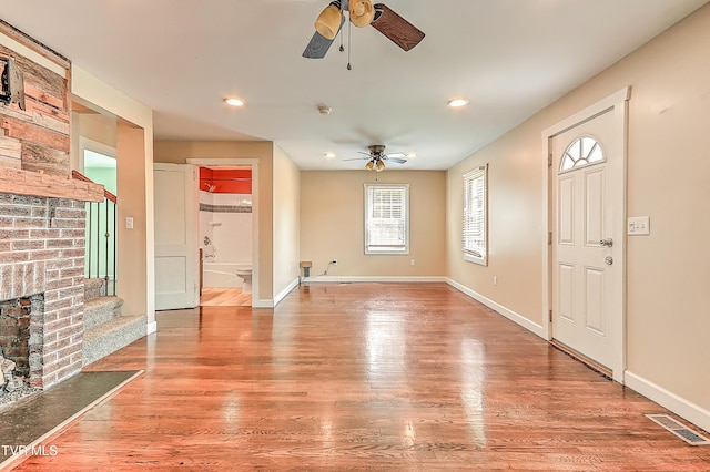 1401 Burgie St, Elizabethton, TN 37643 - unfurnished living room featuring ceiling fan, wood finished floors, baseboards, recessed lighting, and stairs