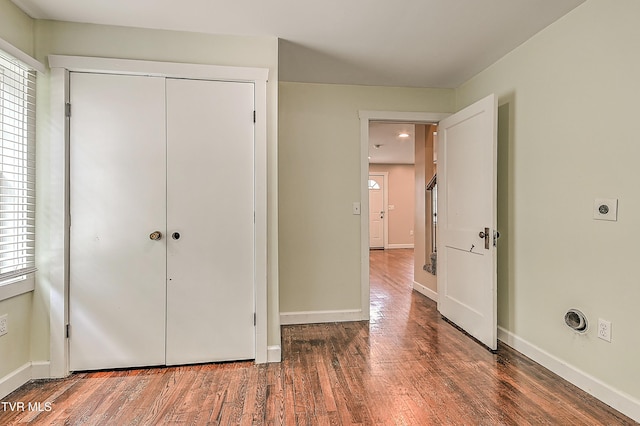 1401 Burgie St, Elizabethton, TN 37643 - unfurnished bedroom featuring wood finished floors, baseboards, a closet, and multiple windows