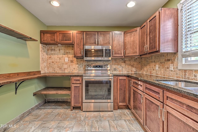1401 Burgie St, Elizabethton, TN 37643 - kitchen featuring stainless steel appliances, decorative backsplash, light stone finish floors, recessed lighting, and brown cabinets