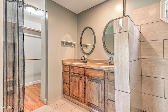 1401 Burgie St, Elizabethton, TN 37643 - full bathroom with wood finished floors, double vanity, and baseboards