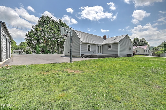 1401 Burgie St, Elizabethton, TN 37643 - back of property featuring metal roof, a yard, a patio, and central AC unit