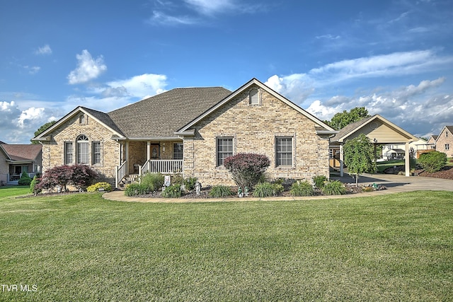 105 Morse Dr, Bristol, TN 37620 - view of front of home with brick siding, a front yard, covered porch, and a carport