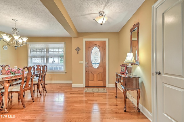 105 Morse Dr, Bristol, TN 37620 - entryway with a chandelier, a textured ceiling, light wood-style floors, and baseboards