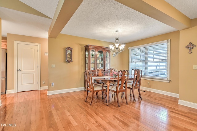 105 Morse Dr, Bristol, TN 37620 - dining room with a textured ceiling, a chandelier, light wood finished floors, and baseboards