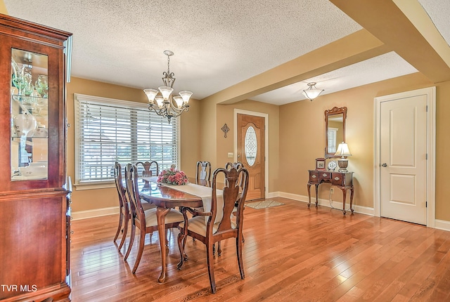 105 Morse Dr, Bristol, TN 37620 - dining space featuring a chandelier, a textured ceiling, light wood-style floors, and baseboards