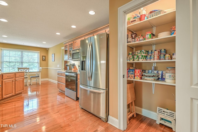 105 Morse Dr, Bristol, TN 37620 - kitchen featuring stainless steel appliances, recessed lighting, baseboards, light wood-style flooring, and glass insert cabinets