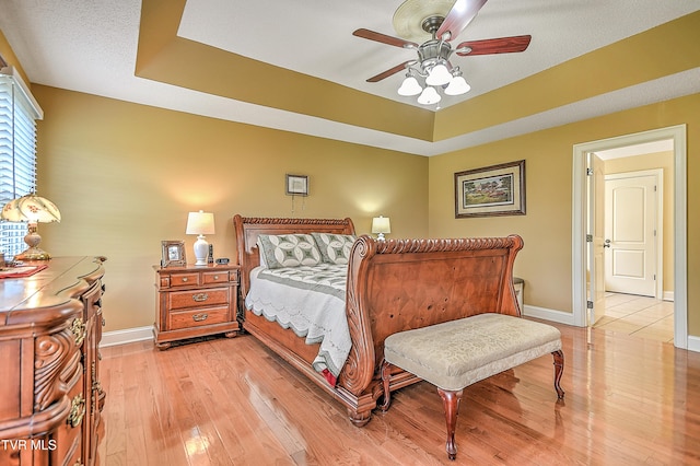 105 Morse Dr, Bristol, TN 37620 - bedroom featuring light wood finished floors, baseboards, a tray ceiling, and a ceiling fan