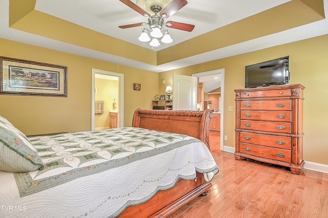 105 Morse Dr, Bristol, TN 37620 - bedroom with light wood finished floors, ensuite bathroom, baseboards, a tray ceiling, and a ceiling fan
