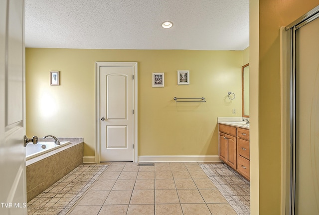 105 Morse Dr, Bristol, TN 37620 - full bathroom with a textured ceiling, vanity, tile patterned flooring, and a garden tub