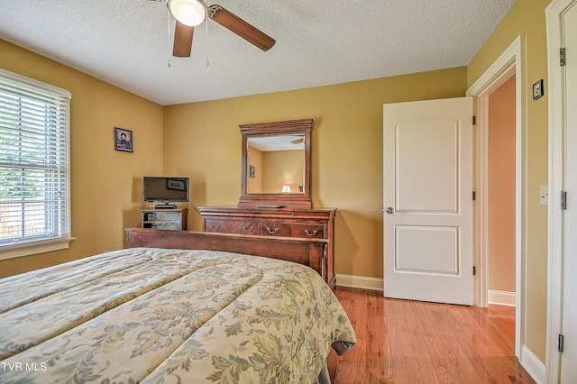 105 Morse Dr, Bristol, TN 37620 - bedroom with wood finished floors, baseboards, ceiling fan, and a textured ceiling