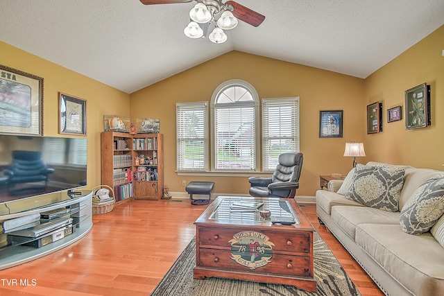 105 Morse Dr, Bristol, TN 37620 - living area featuring a ceiling fan, wood finished floors, vaulted ceiling, baseboards, and a textured ceiling