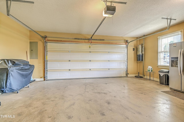 105 Morse Dr, Bristol, TN 37620 - garage with stainless steel fridge, a garage door opener, electric panel, and a central vacuum unit