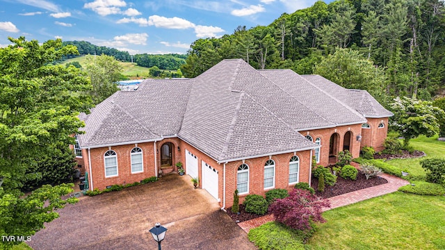 21390 Sheffield Ct, Abingdon, VA 24210 - view of front of house with a garage, brick siding, concrete driveway, a front yard, and a view of trees