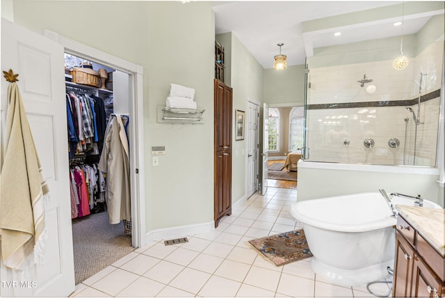21390 Sheffield Ct, Abingdon, VA 24210 - bathroom with a stall shower, vanity, a freestanding bath, tile patterned floors, and a spacious closet
