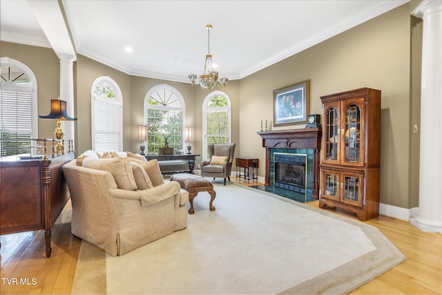21390 Sheffield Ct, Abingdon, VA 24210 - living room featuring wood finished floors, ornate columns, a fireplace, baseboards, and crown molding