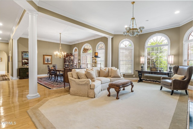21390 Sheffield Ct, Abingdon, VA 24210 - living area featuring decorative columns, a chandelier, light wood finished floors, crown molding, and baseboards