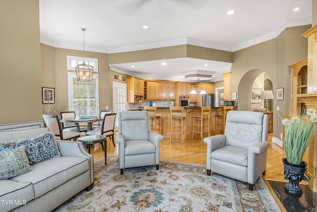 21390 Sheffield Ct, Abingdon, VA 24210 - living area with arched walkways, light wood-style flooring, ornamental molding, a chandelier, and recessed lighting