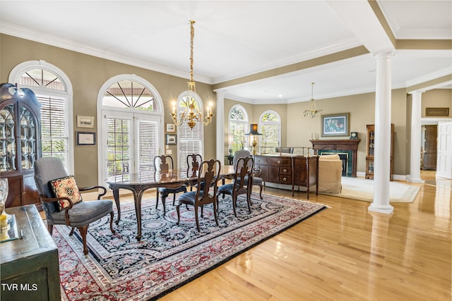 21390 Sheffield Ct, Abingdon, VA 24210 - dining room featuring ornate columns, wood finished floors, a fireplace, crown molding, and a chandelier