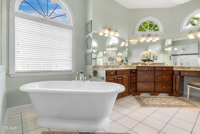 21390 Sheffield Ct, Abingdon, VA 24210 - bathroom featuring a freestanding tub, double vanity, tile patterned floors, a high ceiling, and baseboards
