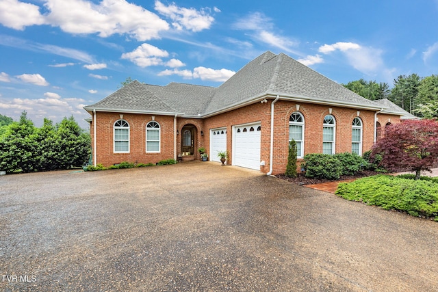 21390 Sheffield Ct, Abingdon, VA 24210 - view of front of house with a garage, driveway, brick siding, and a shingled roof