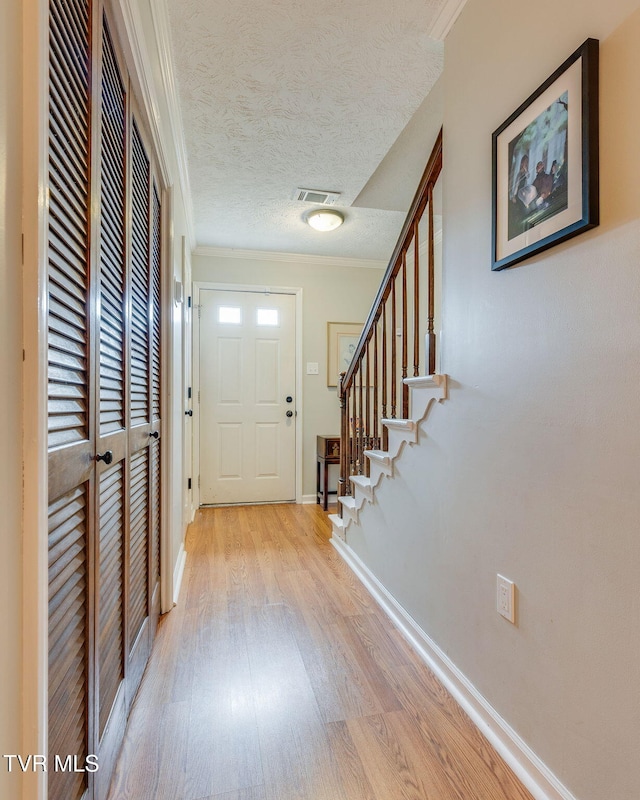 1016 Konnarock Rd # 1, Kingsport, TN 37664 - entrance foyer featuring light wood-style flooring, crown molding, baseboards, stairs, and a textured ceiling
