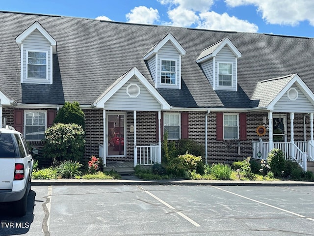 210 Spring St Unit C3, Blountville, TN 37617 - view of front of house featuring brick siding, uncovered parking, and covered porch