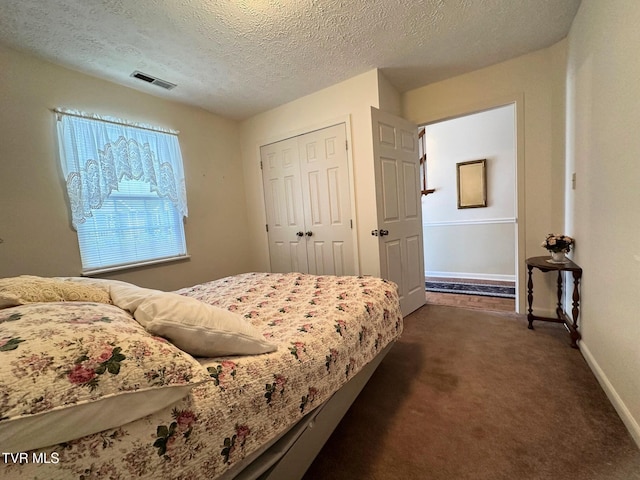 210 Spring St Unit C3, Blountville, TN 37617 - bedroom with dark colored carpet, baseboards, a textured ceiling, and a closet