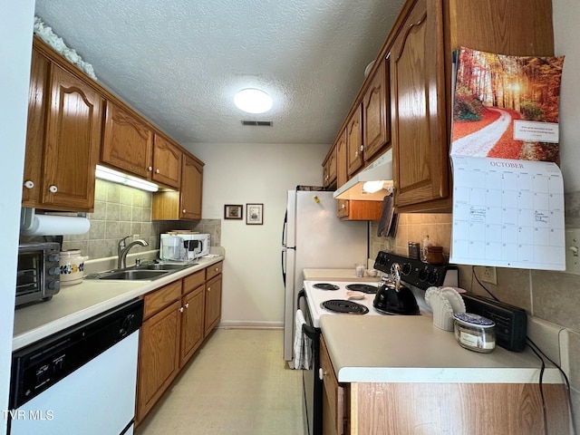 210 Spring St Unit C3, Blountville, TN 37617 - kitchen featuring white appliances, a sink, under cabinet range hood, decorative backsplash, and light countertops