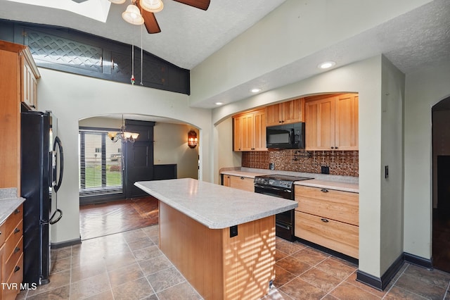 11316 Boggs Hollow Rd, Pound, VA 24279 - kitchen with black appliances, arched walkways, lofted ceiling, light countertops, and a ceiling fan