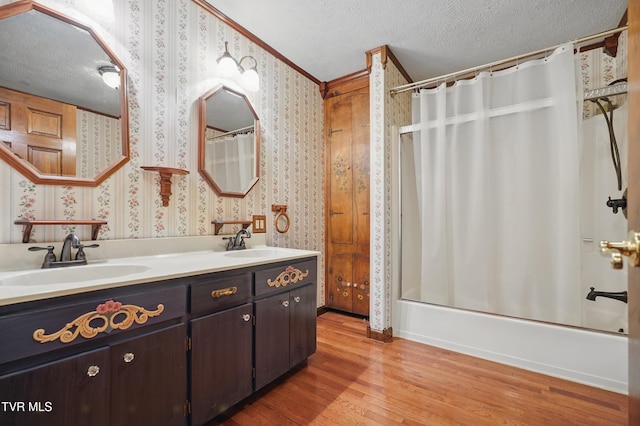 11316 Boggs Hollow Rd, Pound, VA 24279 - bathroom featuring wood finished floors, wallpapered walls, shower / bath combo, double vanity, and a textured ceiling