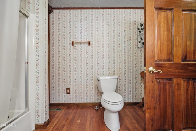 11316 Boggs Hollow Rd, Pound, VA 24279 - bathroom featuring baseboards, wallpapered walls, toilet, wood finished floors, and a shower