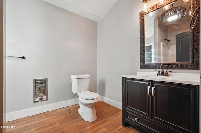 11316 Boggs Hollow Rd, Pound, VA 24279 - bathroom featuring heating unit, vaulted ceiling, toilet, baseboards, and wood finished floors