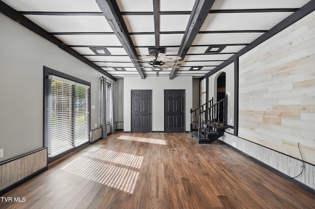11316 Boggs Hollow Rd, Pound, VA 24279 - unfurnished room featuring wood walls, ceiling fan, wood finished floors, arched walkways, and stairs