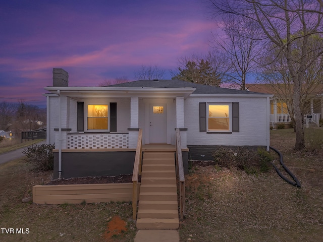 1241 Virginia Ave, Bristol, TN 37620 - ranch-style house featuring a chimney, a porch, a shingled roof, and brick siding