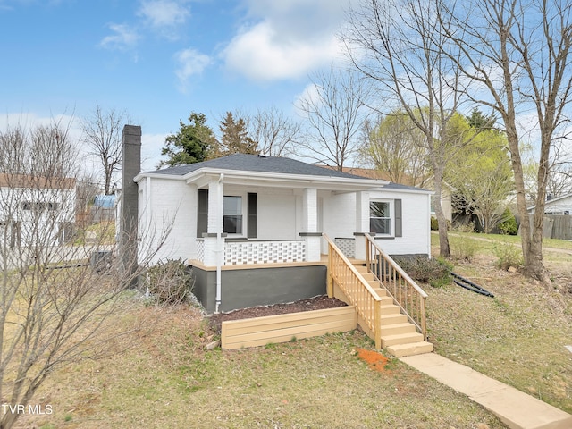 1241 Virginia Ave, Bristol, TN 37620 - bungalow-style house with a chimney, covered porch, brick siding, and roof with shingles