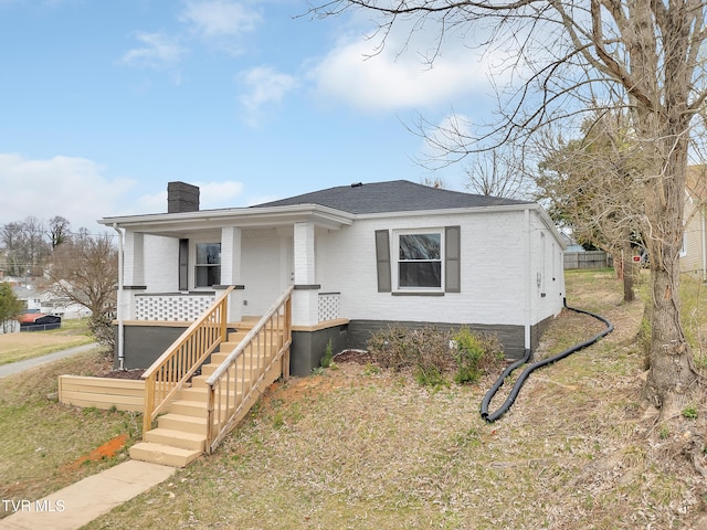 1241 Virginia Ave, Bristol, TN 37620 - bungalow-style house featuring a chimney, brick siding, covered porch, and a shingled roof