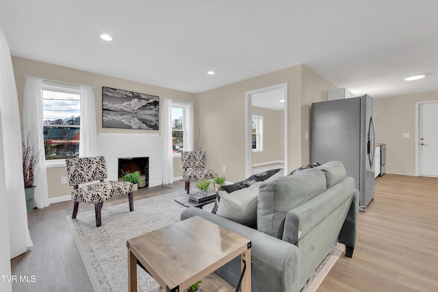 1241 Virginia Ave, Bristol, TN 37620 - living area featuring light wood-style flooring, a brick fireplace, recessed lighting, and baseboards