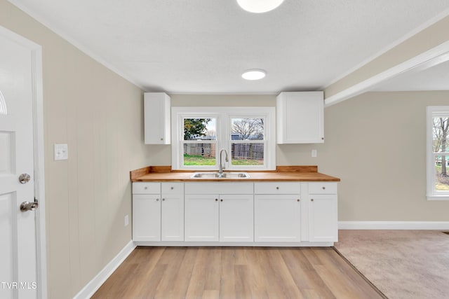 1241 Virginia Ave, Bristol, TN 37620 - kitchen with a sink, wooden counters, white cabinets, and baseboards