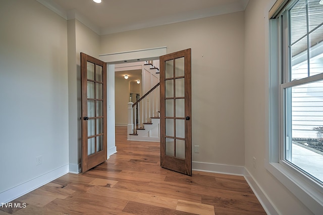 203 Riverwatch Cir, Kingsport, TN 37660 - spare room featuring plenty of natural light, stairway, light wood-style floors, ornamental molding, and baseboards