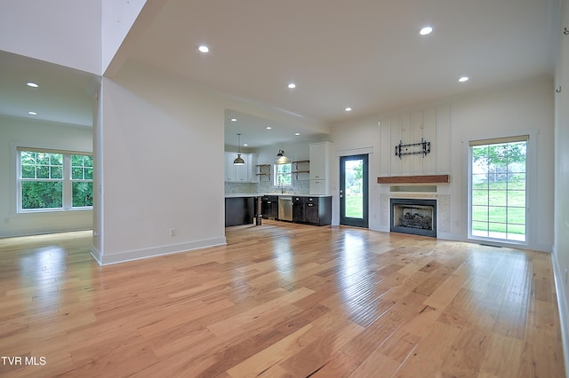 203 Riverwatch Cir, Kingsport, TN 37660 - unfurnished living room with healthy amount of natural light, light wood-style flooring, recessed lighting, and a fireplace