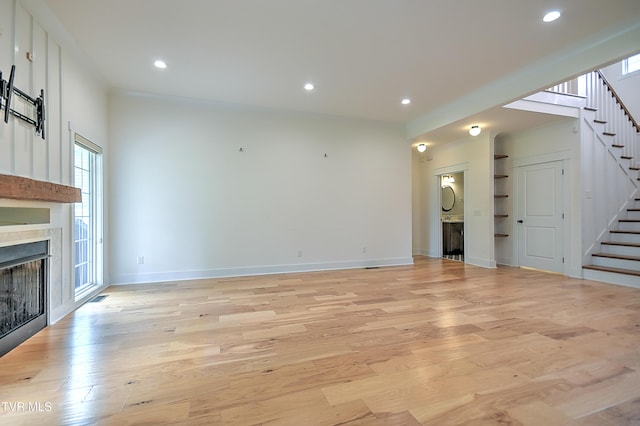 203 Riverwatch Cir, Kingsport, TN 37660 - unfurnished living room with a fireplace, stairway, light wood-style flooring, recessed lighting, and baseboards
