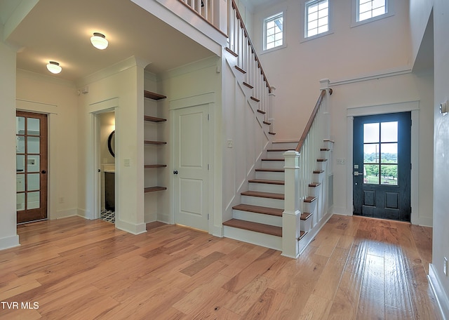 203 Riverwatch Cir, Kingsport, TN 37660 - foyer entrance with light wood-style flooring, stairs, a towering ceiling, ornamental molding, and baseboards